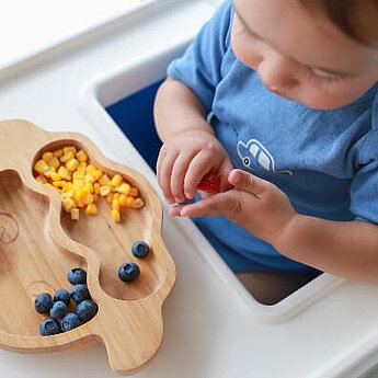 Toddler eating blueberries