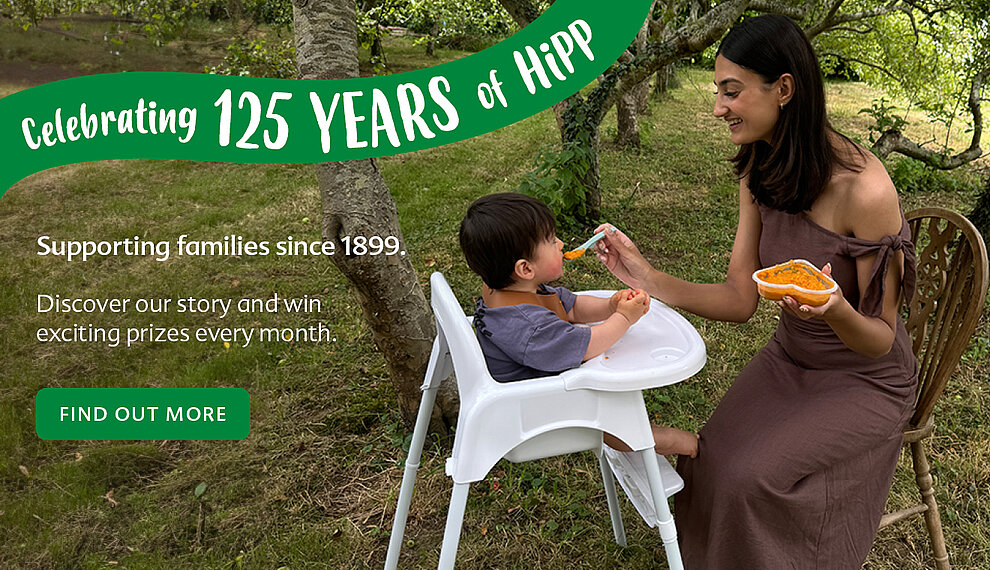 Mum feeding her baby a HiPP baby food jar