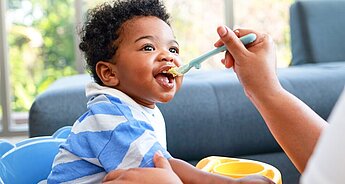 Baby eating greens